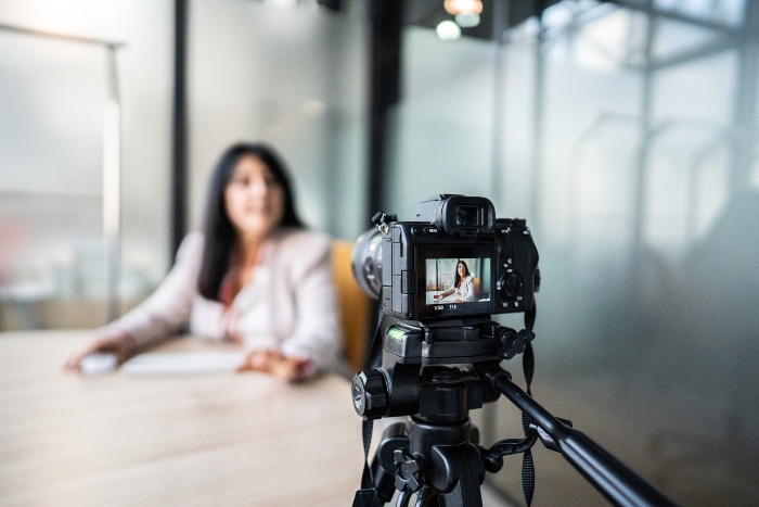 Woman enjoying corporate video production service by Spectrum Audio Visual in Denver, CO