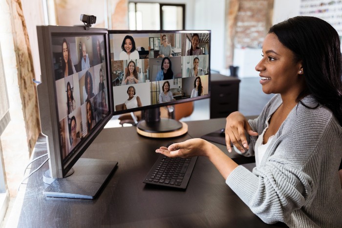 A woman attending a high-quality virtual corporate event produced by Spectrum Audio Visual in Denver